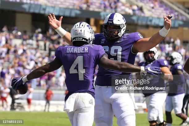 Taye Barber and Coy McMillon of the TCU Horned Frogs celebrate a third quarter touchdown against the Iowa State Cyclones at Amon G. Carter Stadium on...