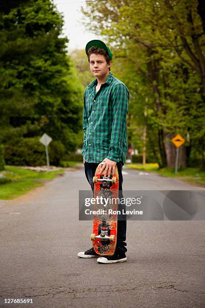 teen boy with skateboard, portrait - checked shirt stock pictures, royalty-free photos & images