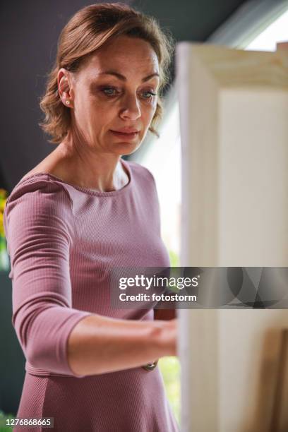 focused woman enjoying painting - canvas easel isolated stock pictures, royalty-free photos & images