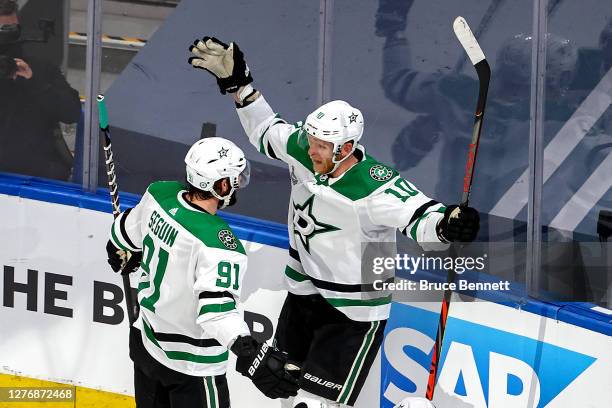 Corey Perry of the Dallas Stars is congratulated by Tyler Seguin after scoring a goal against the Tampa Bay Lightning during the first period in Game...