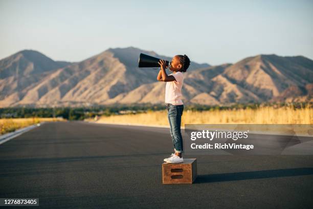 young girl with megaphone - persuasion imagens e fotografias de stock