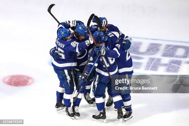 Mikhail Sergachev of the Tampa Bay Lightning is congratulated by his teammates after scoring a goal against the Dallas Stars during the third period...