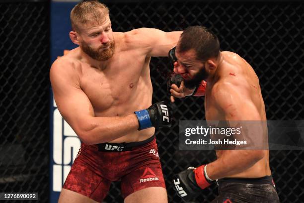 Jan Blachowicz of Poland punches Dominick Reyes in their light heavyweight championship bout during UFC 253 inside Flash Forum on UFC Fight Island on...