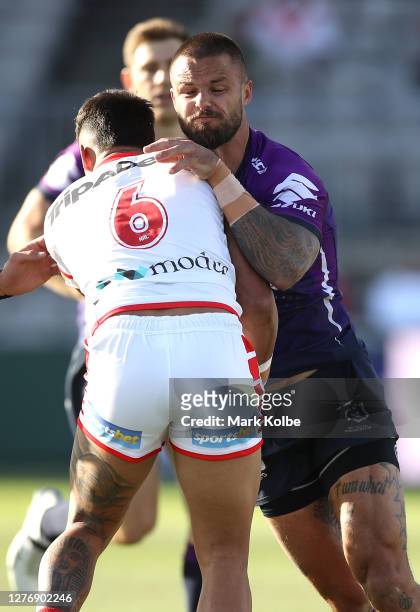 Sandor Earl of the Storm is tackled during the round 20 NRL match between the St George Illawarra Dragons and the Melbourne Storm at Netstrata...