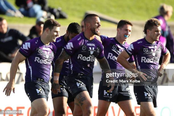 Sandor Earl of the Storm is congratulated by team mates after scoring a try during the round 20 NRL match between the St George Illawarra Dragons and...