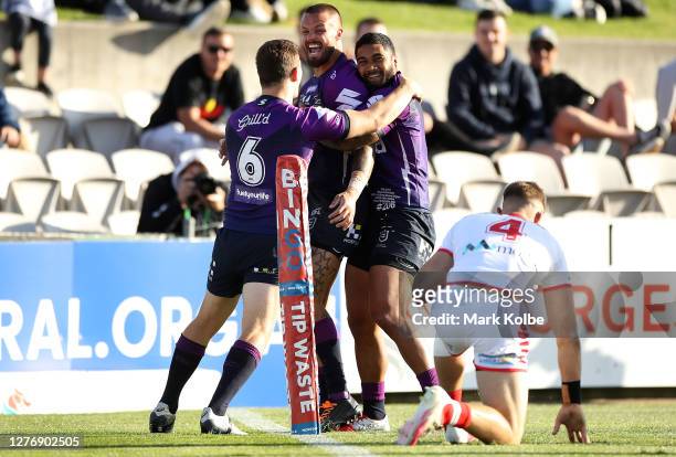 Sandor Earl of the Storm is congratulated by team mates after scoring a try during the round 20 NRL match between the St George Illawarra Dragons and...