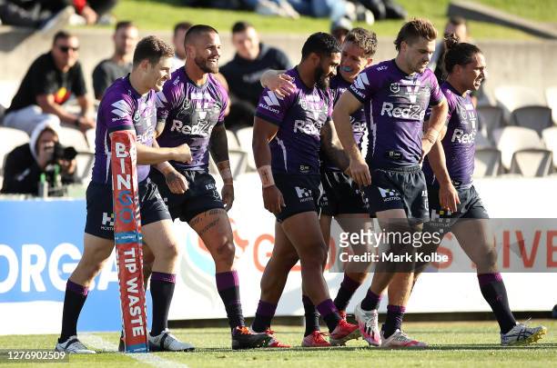 Sandor Earl of the Storm is congratulated by team mates after scoring a try during the round 20 NRL match between the St George Illawarra Dragons and...