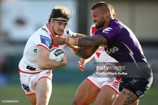 Cody Ramsey of the Dragons is tackled by Sandor Earl of the Storm during the round 20 NRL match between the St George Illawarra Dragons and the...