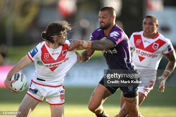 Cody Ramsey of the Dragons is tackled by Sandor Earl of the Storm during the round 20 NRL match between the St George Illawarra Dragons and the...