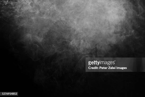 smoke against black background - nebbia foto e immagini stock
