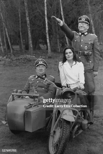 From left to right, actors Richard Marner as Colonel Kurt von Strohm, Francesca Gonshaw as waitress Maria Recamier and Sam Kelly as Captain Hans...