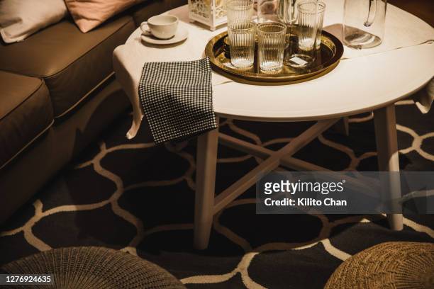 drinking glass on coffee table - coffee table foto e immagini stock