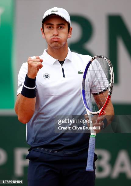 Elliot Benchetrit of France celebrates after winning a point during his Men's Singles first round match against John Isner of the United States...