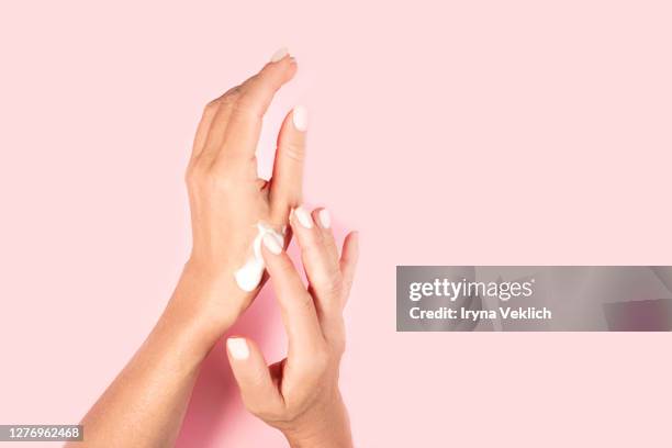 woman's hands and hand cream. - handschoen stock-fotos und bilder