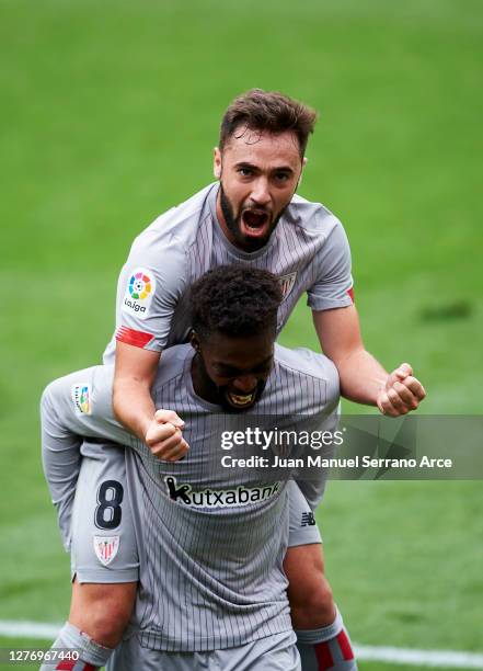 Unai Lopez of Athletic Bilbao celebrates with teammate Inaki Williams after scoring his sides first goal during the La Liga Santander match between...