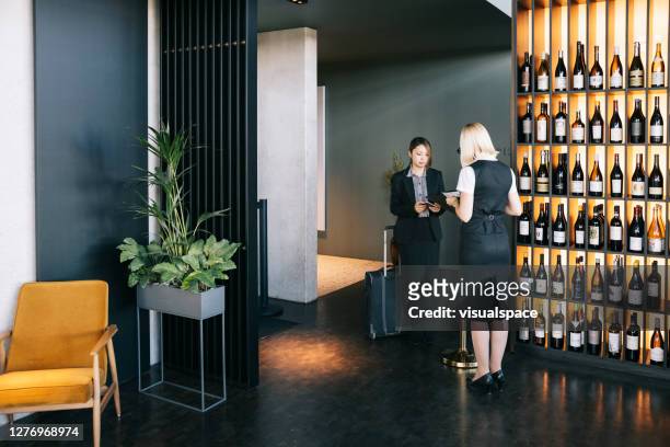woman entering to business lounge at the airport - first class lounge stock pictures, royalty-free photos & images