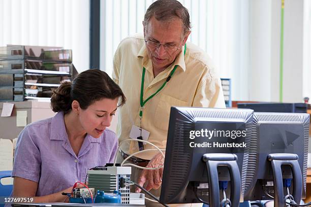 professor stepping through functions of programmable logic controller - programmable logic controller stock pictures, royalty-free photos & images