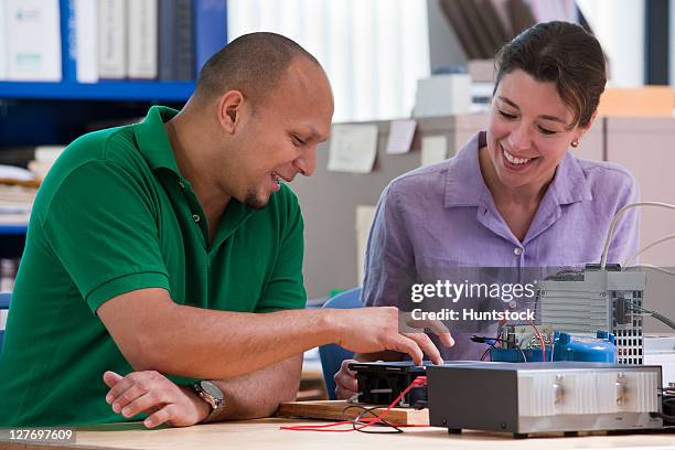 engineering students using touch screen to set up programmable logic controller - programmable logic controller stock pictures, royalty-free photos & images
