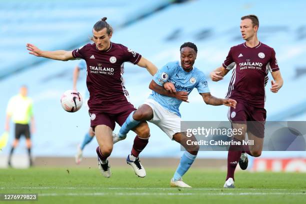 Caglar Soyuncu of Leicester City battles for possession with Raheem Sterling of Manchester City during the Premier League match between Manchester...