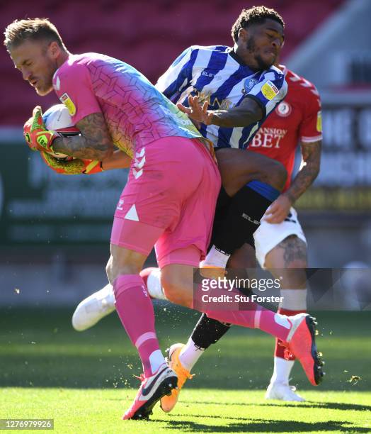 Sheffield Wednesday player Kadeem Harris challenges City goalkeeper Daniel Bentley during the Sky Bet Championship match between Bristol City and...