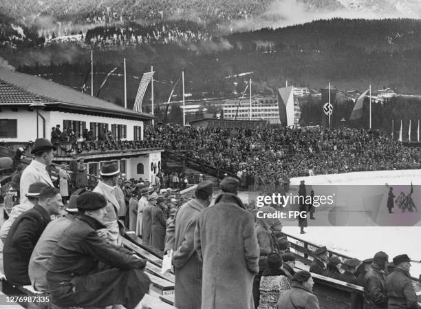 View of the grandstands of the Grosse Olympiaschanze with the flags of all participating nations of the 1936 Winter Olympics in...