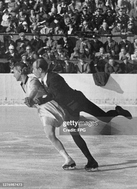 German figure skater Maxi Herber and German figure skater Ernst Baier , watched by spectators in the background, as they perform their routine in the...