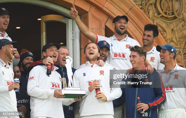 Tom Westley of Essex lifts the Bob Willis Trophy surrounded by his team mates on the balcony during Day Five of the Bob Willis Trophy Final match...