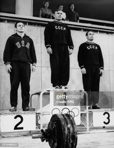 American weightlifter Stanley Stanczyk , Soviet weightlifter Trofim Lomakin , and Soviet weightlifter Arkady Vorobyev on the winners' podium...