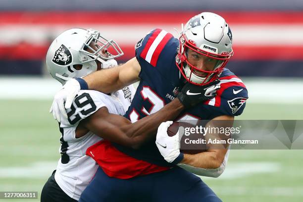 Lamarcus Joyner of the Las Vegas Raiders attempts to tackle Rex Burkhead of the New England Patriots during the first half at Gillette Stadium on...