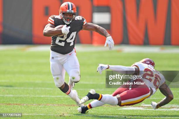 Running back Nick Chubb of the Cleveland Browns breaks a tackle from strong safety Landon Collins of the Washington Football Team as he runs for a...