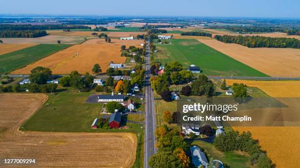 aerial of small town in autumn - country town stock-fotos und bilder