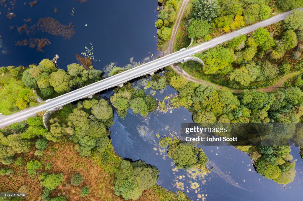 The high angle view looking down on a disused railway viaduct in rural Scotland