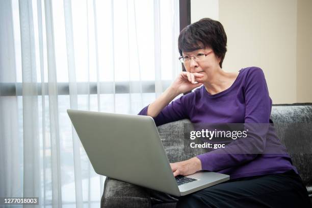 empresaria asiática usando portátil y trabajando desde casa - purple shirt fotografías e imágenes de stock