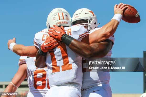 Quarterback Sam Ehlinger of the Texas Longhorns celebrates scoring a touchdown with lineman Denzel Okafor during the first half of the college...