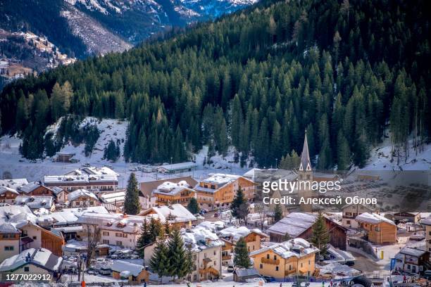 winter cityscape of ski resort arabba in dolomites mountains, italy - badia stock pictures, royalty-free photos & images