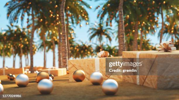 sand beach and palms with christmas decoration - summer christmas stock pictures, royalty-free photos & images