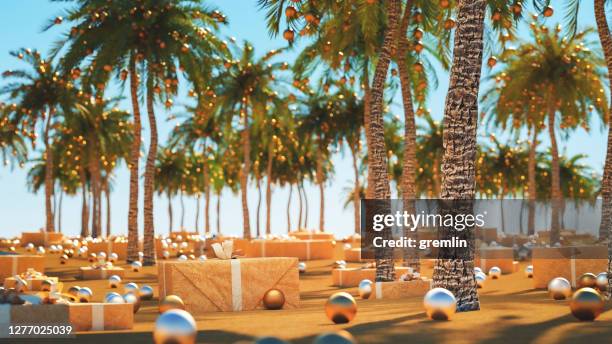 sand beach and palms with christmas decoration - christmas palm tree stock pictures, royalty-free photos & images