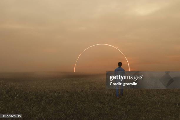 slaapwandelaar in fantasieweide die in geheimzinnige passage loopt - space man stockfoto's en -beelden