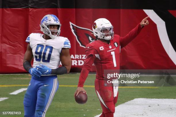 Quarterback Kyler Murray of the Arizona Cardinals celebrates after scoring on a 1-yard rushing touchdown against defensive end Trey Flowers of the...