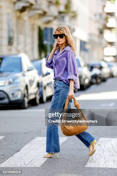 Influencer Gitta Banko, wearing a purple colored oversize blouse by Gitta Banko,a pearl necklace by Hermina Athens, a golden necklace by Bottega...