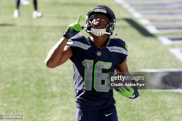 Tyler Lockett of the Seattle Seahawks celebrates in the end zone after scoring a touchdown against the Dallas Cowboys during the second quarter in...