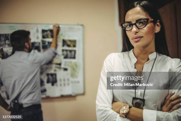 police office colleagues working together on crime investigation - man and woman, detectives and fbi agents working together on a case in office - chief technology officer stock pictures, royalty-free photos & images