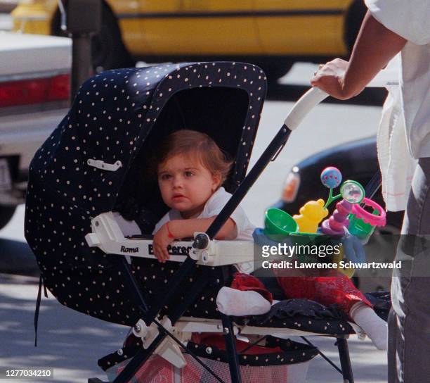 Lourdes Leon, daughter of Madonna and Carlos Leon, seen in stroller at 11 months old, outside Madonna's Central Park West building with nanny....