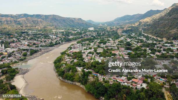 hanging bridge that passes over a river surrounded by a lot of vegetation in honda, tolima / colombia - stan honda bildbanksfoton och bilder