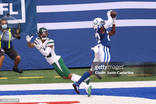 Xavier Rhodes of the Indianapolis Colts intercepts the ball intended for Lawrence Cager of the New York Jets during the second quarter in at Lucas...