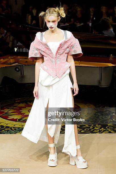 Model walks the runway during the Vivienne Westwood Ready to Wear Spring / Summer 2012 show during Paris Fashion Week at Grand Hotel Intercontinental...