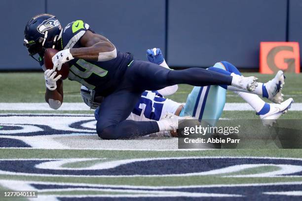 Metcalf of the Seattle Seahawks scores a 29 yard touchdown against Darian Thompson of the Dallas Cowboys during the fourth quarter in the game at...
