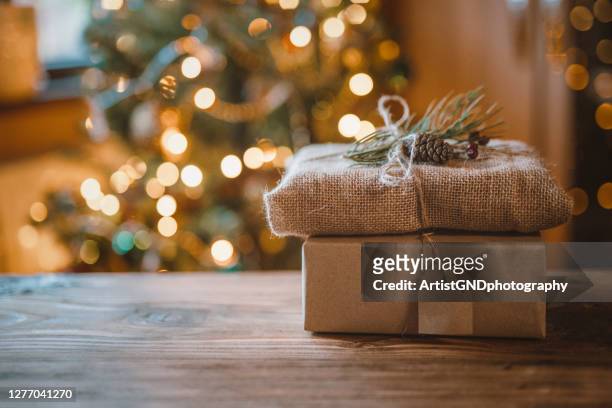 photo of a beautifully decorated christmas gifts packaged only with biodegradable materials - christmas green stock pictures, royalty-free photos & images