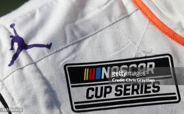 Detail view of the Jumpman logo on the suit of Denny Hamlin, driver of the FedEx Office Toyota, as he stands on the grid prior to the NASCAR Cup...