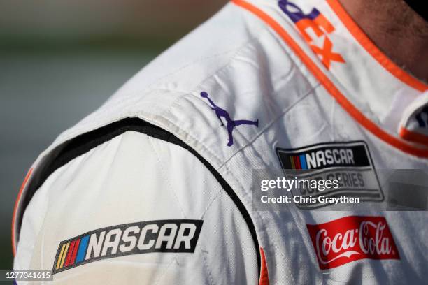 Detail view of the Jumpman logo on the suit of Denny Hamlin, driver of the FedEx Office Toyota, as he stands on the grid prior to the NASCAR Cup...